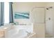 Bright bathroom featuring a soaking tub, glass-enclosed shower, tile, and soft blue accents at 8491 Oasis Key Cv, Kissimmee, FL 34747