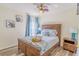 Cozy bedroom with marine decor, wood-look flooring, and a large window for natural light at 8491 Oasis Key Cv, Kissimmee, FL 34747