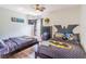 Themed bedroom with two beds, Batman decor, wood floors, and a ceiling fan at 8491 Oasis Key Cv, Kissimmee, FL 34747