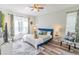 Bright bedroom with large windows, wood-look flooring, and stylish decor creating a relaxing ambiance at 8491 Oasis Key Cv, Kissimmee, FL 34747