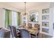 Elegant dining room featuring a chandelier, dining table with seating for six, and decorative nooks at 8491 Oasis Key Cv, Kissimmee, FL 34747