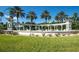 Emerald Island Resort entrance with a water feature, palm trees, and a well-maintained lawn at 8491 Oasis Key Cv, Kissimmee, FL 34747