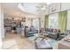 Open-concept living room with modern decor, hardwood floors, and an adjoining kitchen and dining area at 8491 Oasis Key Cv, Kissimmee, FL 34747