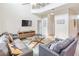 Bright living room with hardwood floors, leather sofas, ceiling fan, and a glass-topped coffee table at 8491 Oasis Key Cv, Kissimmee, FL 34747