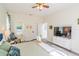 Spacious main bedroom with ceiling fan, ensuite bathroom with a soaking tub, and TV on the dresser at 8491 Oasis Key Cv, Kissimmee, FL 34747