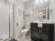 Well-lit bathroom featuring a vanity with storage and a glass-enclosed shower at 8947 Stinger Dr, Davenport, FL 33896