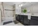 Bright bathroom featuring a dual sink vanity, framed mirror, and a shower with a tub at 8947 Stinger Dr, Davenport, FL 33896