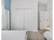 Bedroom showcasing twin beds, neutral carpet, and a closet with paneled doors at 8947 Stinger Dr, Davenport, FL 33896