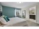 Modern bedroom with a blue accent wall, a window view, and ensuite bathroom access at 8947 Stinger Dr, Davenport, FL 33896