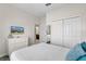 Bedroom with a white dresser and a flat screen TV hanging on the wall at 8947 Stinger Dr, Davenport, FL 33896