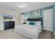 Comfortable bedroom with a queen bed, TV, blue accent pillows, and contemporary decor at 8947 Stinger Dr, Davenport, FL 33896