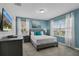 Comfortable bedroom with bright windows, a TV, and stylish décor at 8947 Stinger Dr, Davenport, FL 33896