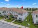 Inviting townhome featuring neutral paint, a tiled roof, neat landscaping and a private covered porch at 8947 Stinger Dr, Davenport, FL 33896