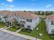 Inviting townhome featuring neutral paint, a tiled roof, neat landscaping and a private covered porch at 8947 Stinger Dr, Davenport, FL 33896