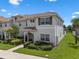 Beautifully landscaped two-story home with tiled roof and well-maintained lawn at 8947 Stinger Dr, Davenport, FL 33896