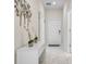 Bright hallway features marble tiled floors, white walls, and modern decor at 8947 Stinger Dr, Davenport, FL 33896