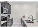 Bright, modern kitchen with stainless steel appliances and breakfast bar at 8947 Stinger Dr, Davenport, FL 33896
