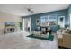 Living room featuring marble floors, modern furniture, and a sliding glass door at 8947 Stinger Dr, Davenport, FL 33896