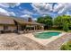 Landscaped backyard with a swimming pool, patio, and home with chimney and Florida room at 1016 Ohanlon Ct, Oviedo, FL 32765