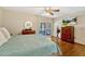Cozy bedroom with hardwood floors, ceiling fan, and sliding glass doors to outdoor seating at 1016 Ohanlon Ct, Oviedo, FL 32765