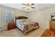 Comfortable bedroom with soft carpet, cozy bed, and a window with classic shutter design at 1016 Ohanlon Ct, Oviedo, FL 32765