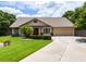 Charming single-story home featuring a well-manicured lawn, stone accents, and a two-car garage at 1016 Ohanlon Ct, Oviedo, FL 32765