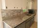 Modern kitchen counter with granite countertops and stylish backsplash at 1203 Atlantic Ct, Kissimmee, FL 34759