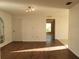 Bright living room showcasing wood flooring, a modern track lighting fixture, and neutral walls at 1203 Atlantic Ct, Kissimmee, FL 34759
