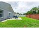 Spacious backyard with a patio set, grassy lawn, privacy fence, and brick wall at 1659 Sage Creek Ct, Orlando, FL 32824