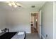 Comfortable bedroom with neutral walls, ceiling fan, and a doorway leading to another room at 1659 Sage Creek Ct, Orlando, FL 32824