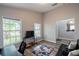 Comfortable bonus room with hardwood flooring, gaming decor, and plenty of natural light at 1659 Sage Creek Ct, Orlando, FL 32824