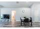 The open floor plan features a dining area with wood-look flooring and neutral paint at 1659 Sage Creek Ct, Orlando, FL 32824