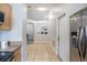 View of the entry hallway leading into the main living space and kitchen at 1659 Sage Creek Ct, Orlando, FL 32824