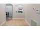 Neutral hallway with tile flooring leading to a cozy living space with an arched doorway at 1659 Sage Creek Ct, Orlando, FL 32824