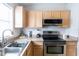 The kitchen features wooden cabinets and stainless steel appliances at 1659 Sage Creek Ct, Orlando, FL 32824