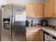 This kitchen features stainless steel appliances and wood cabinets at 1659 Sage Creek Ct, Orlando, FL 32824