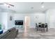 Open-concept living room features wood flooring, a ceiling fan, and neutral walls at 1659 Sage Creek Ct, Orlando, FL 32824