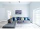 Spacious living room with wood floors, and a comfortable sectional at 1659 Sage Creek Ct, Orlando, FL 32824