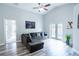 Bright living room with wood floors, and a comfortable gray sectional at 1659 Sage Creek Ct, Orlando, FL 32824