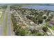Expansive aerial shot displaying a neighborhood next to a highway, set against a backdrop of multiple lakes at 166 Paradise Island Dr, Haines City, FL 33844