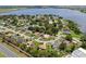 Expansive aerial view of a neighborhood near a lake with tree-lined streets and well-maintained homes at 166 Paradise Island Dr, Haines City, FL 33844