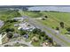 An aerial view showcasing the property's proximity to the highway, nearby lake, and surrounding neighborhood at 166 Paradise Island Dr, Haines City, FL 33844