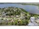 Scenic aerial shot showcasing a lakeside community with lush greenery and diverse residential architecture at 166 Paradise Island Dr, Haines City, FL 33844
