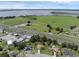 An aerial shot of a neighborhood near a highway, showcasing a lake and nearby commercial area at 166 Paradise Island Dr, Haines City, FL 33844