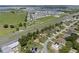 Sprawling aerial view showcasing a neighborhood near a lake, park, and highway, blending nature and accessibility at 166 Paradise Island Dr, Haines City, FL 33844
