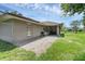 Relaxing backyard featuring a brick patio and well-maintained lawn at 166 Paradise Island Dr, Haines City, FL 33844
