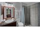 Well-lit bathroom featuring tiled shower, vanity, and modern fixtures at 166 Paradise Island Dr, Haines City, FL 33844