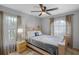 Well-lit bedroom showcasing neutral color scheme, window views, and tile flooring at 166 Paradise Island Dr, Haines City, FL 33844