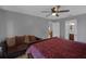 Bedroom featuring a red bed and sofa, creating a cozy and inviting atmosphere at 166 Paradise Island Dr, Haines City, FL 33844