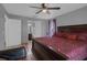 Bedroom featuring a red bed, window and access to private bathroom at 166 Paradise Island Dr, Haines City, FL 33844